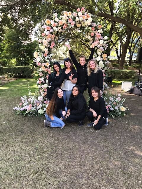 Women Posing Floral Arch